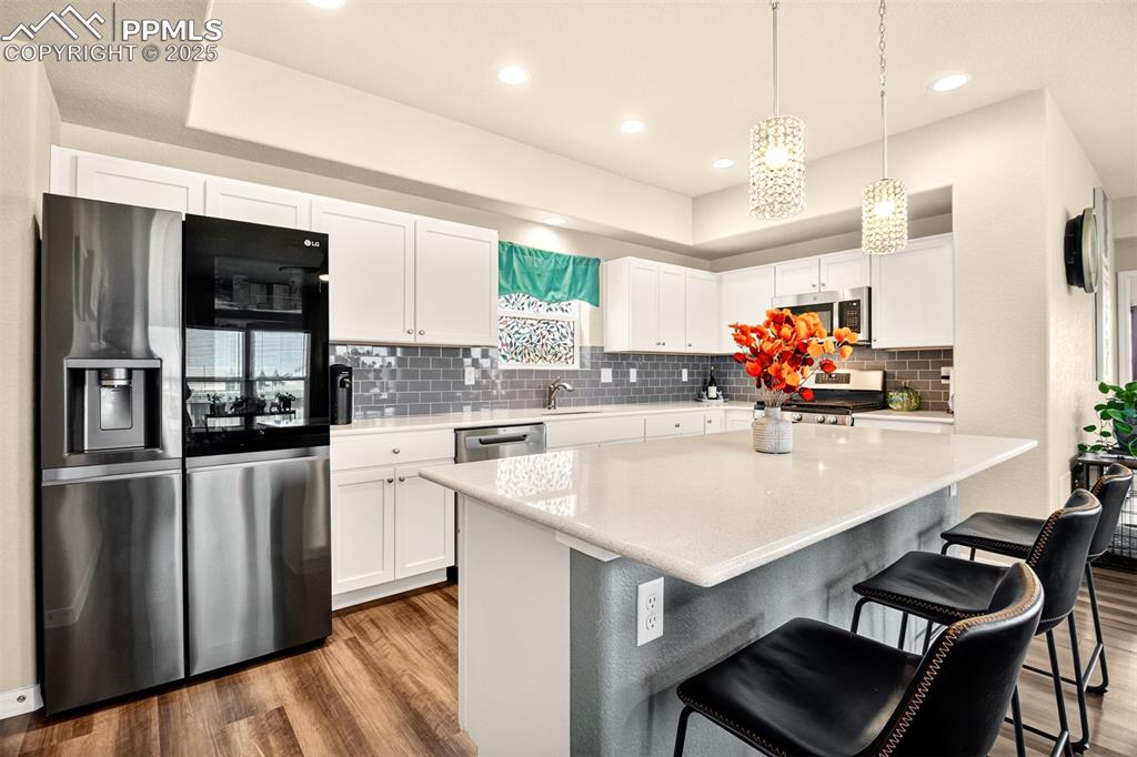 Image 5 of 31: New SS fridge with "ice ball" feature, quartz countertops and new pendant l
