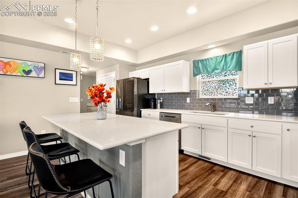 Image 7 of 31: Large breakfast bar, beautiful luxury vinly plank flooring and a large pant