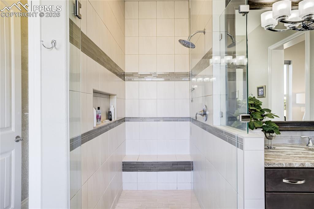 Image 22 of 50: Spa-inspired bath with freestanding soaking tub, dual vanities and zero-ent