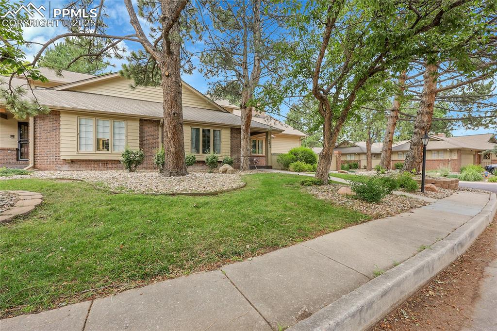 Image 3 of 36: Single story home featuring brick siding and a front yard
