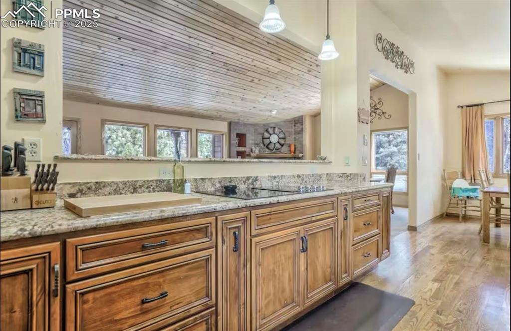 Image 11 of 48: Bathroom with vanity, light wood finished floors, and wooden ceiling
