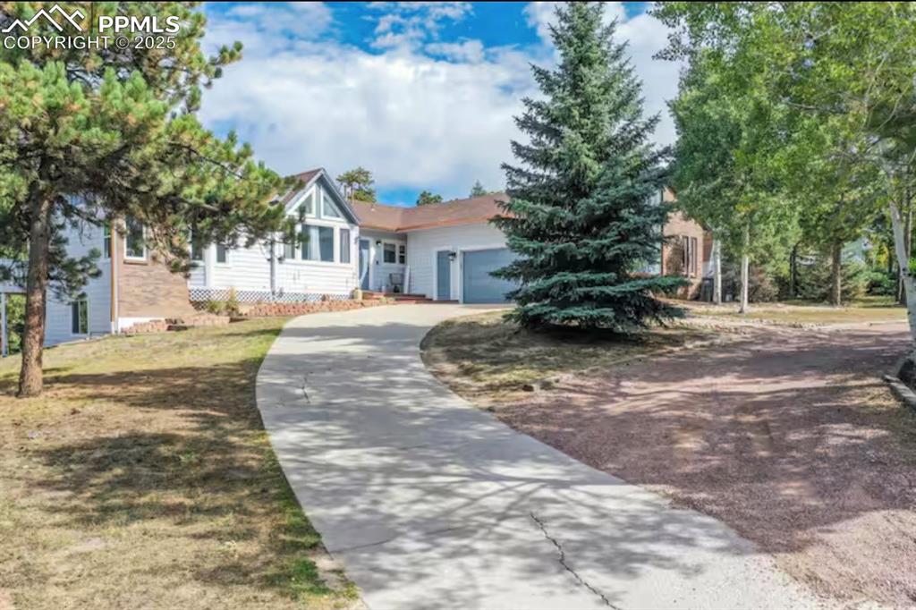 Image 2 of 48: View of front of home featuring driveway and a garage