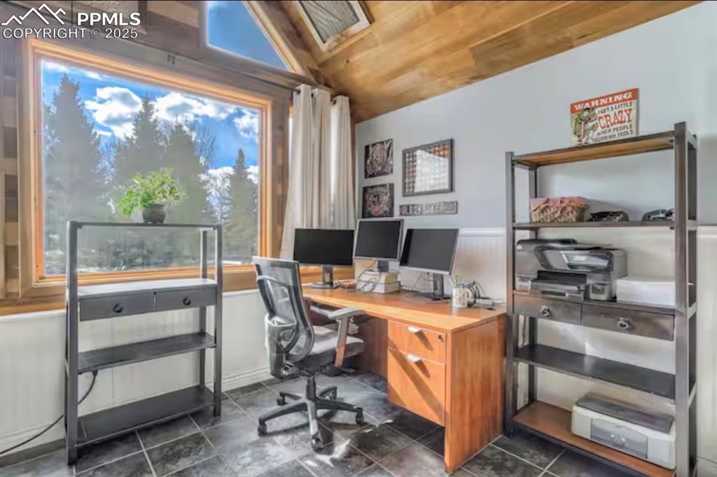 Image 20 of 48: Office area with lofted ceiling, a wainscoted wall, and wooden ceiling