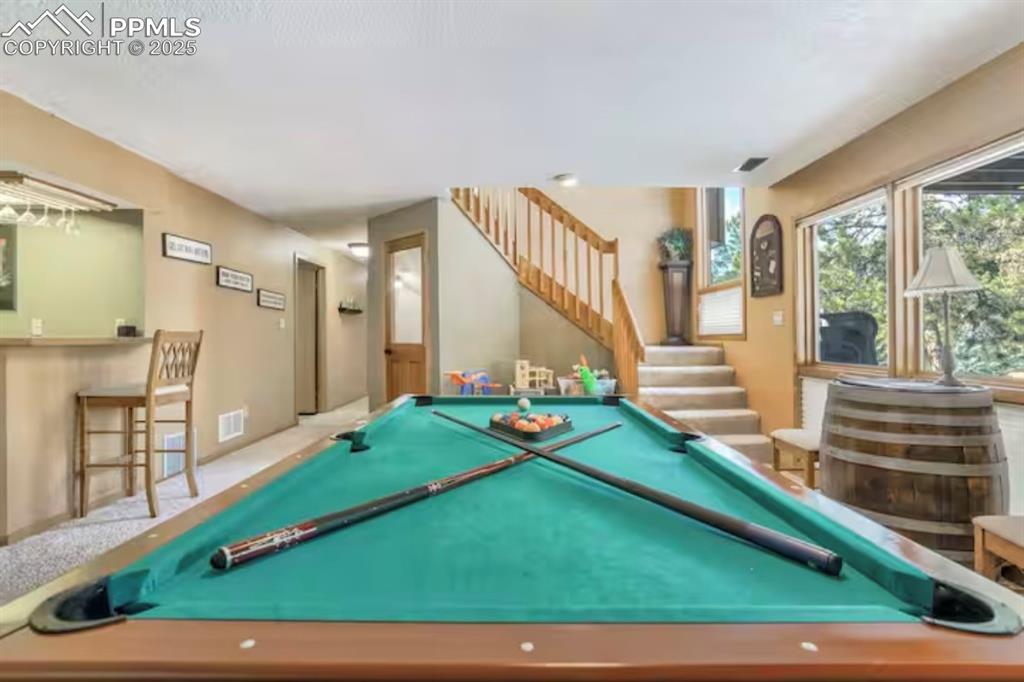 Image 26 of 48: Game room with billiards table and carpet