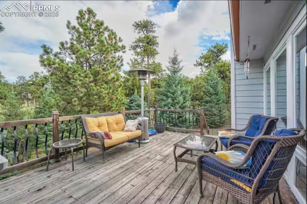 Image 37 of 48: Deck featuring an outdoor living space