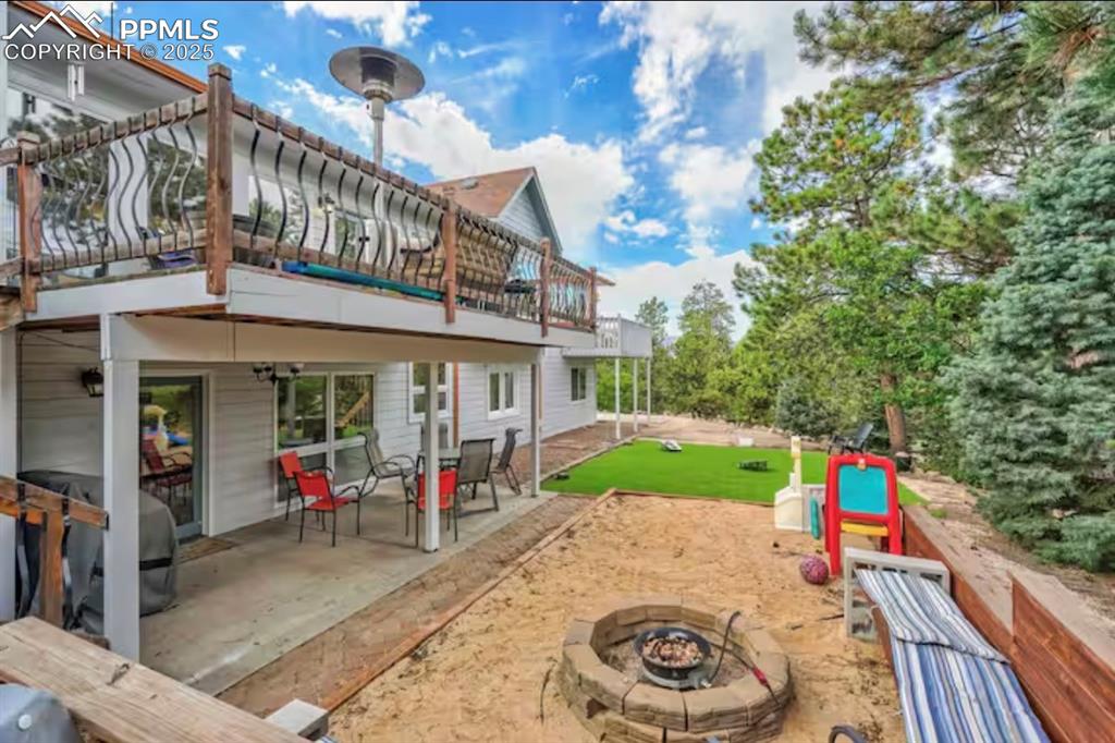 Image 42 of 48: Back of property featuring a patio and a fire pit
