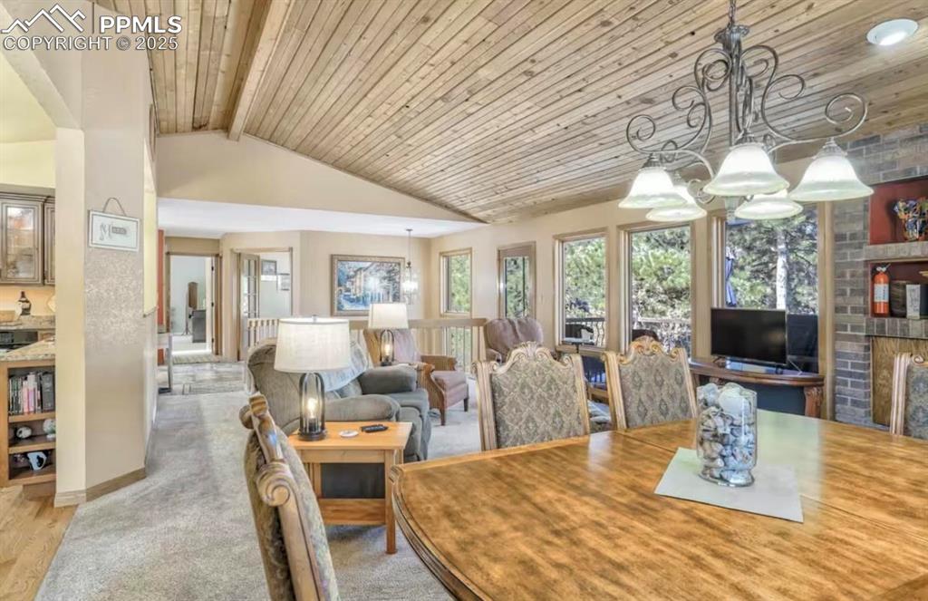 Image 6 of 48: Dining room with wood ceiling and carpet floors
