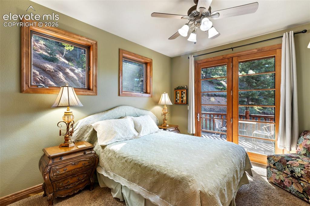 Image 41 of 50: Main level bedroom w/ private deck