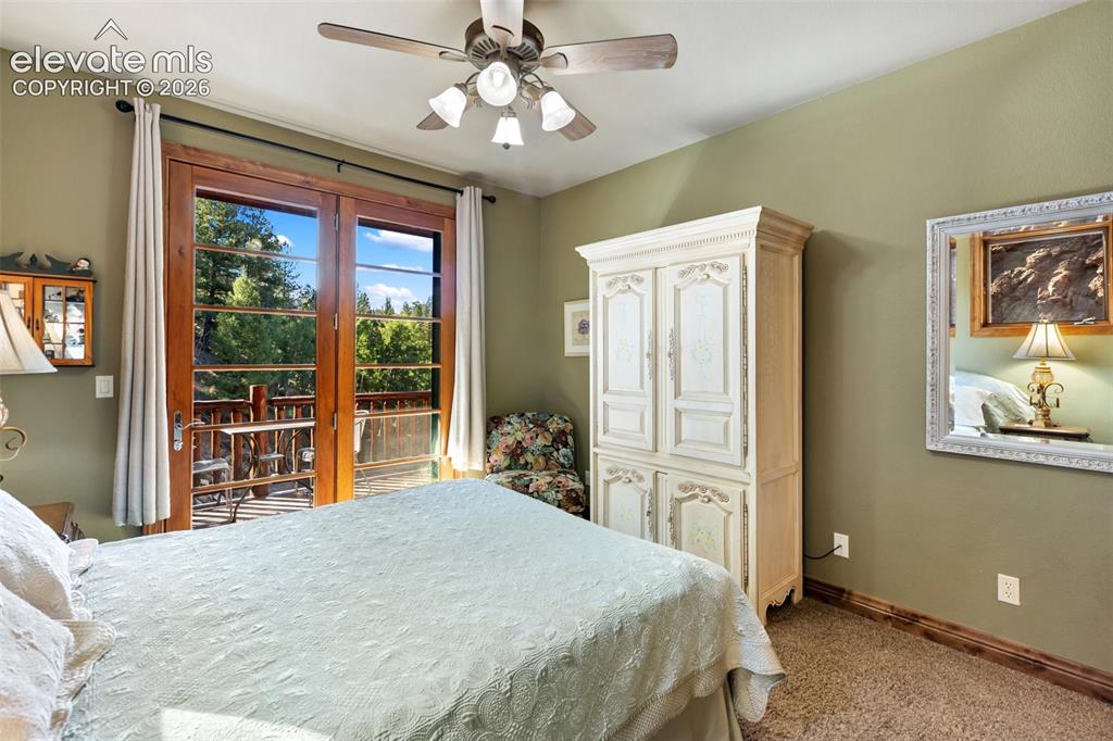 Image 42 of 50: Main level bedroom w/ private deck