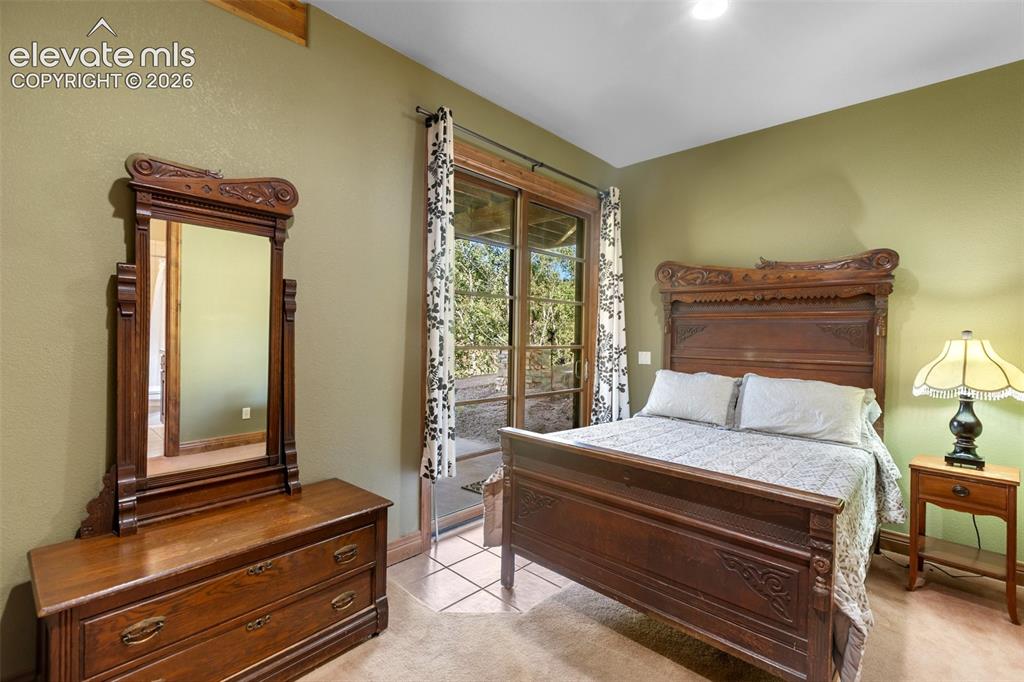 Image 46 of 50: Basement bedroom with access to private patio