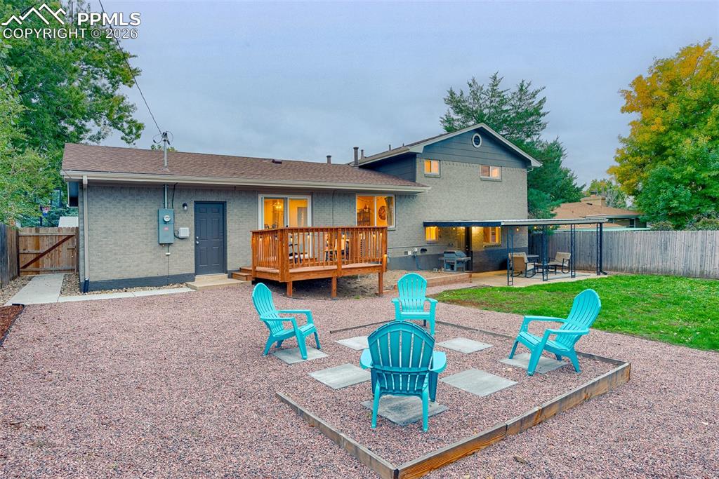 Image 12 of 50: backyard landscaping with gravel and paver patio and garage exit