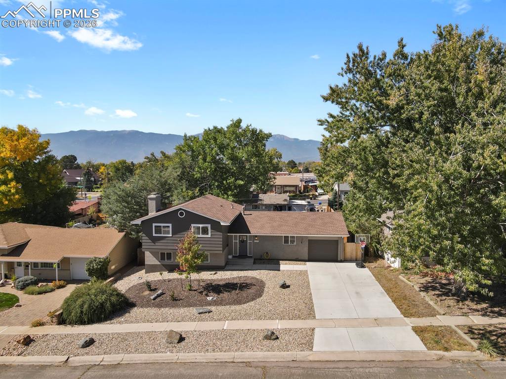 Image 20 of 50: Front of the property with xeriscaping and extra wide driveway