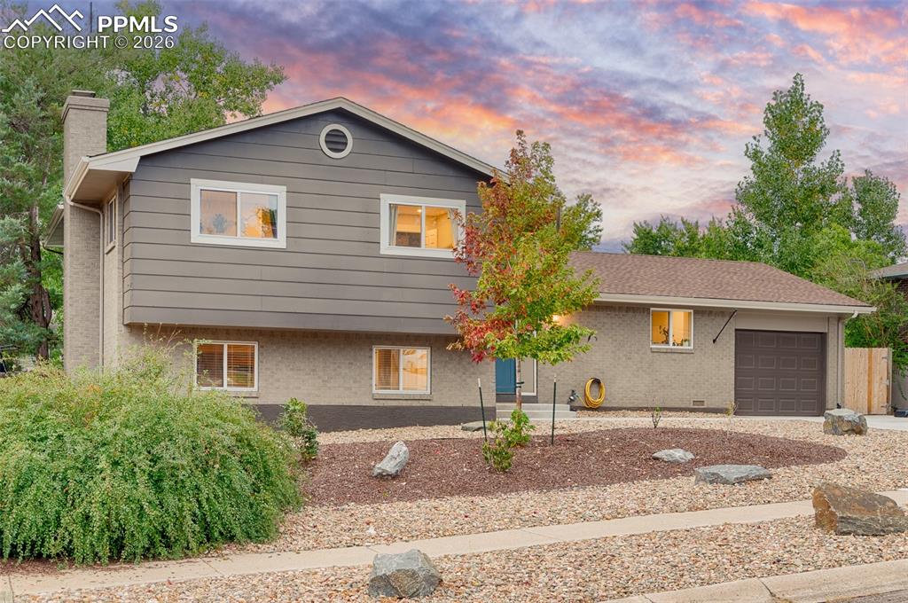 Image 8 of 50: Front of the home with xeriscaping 