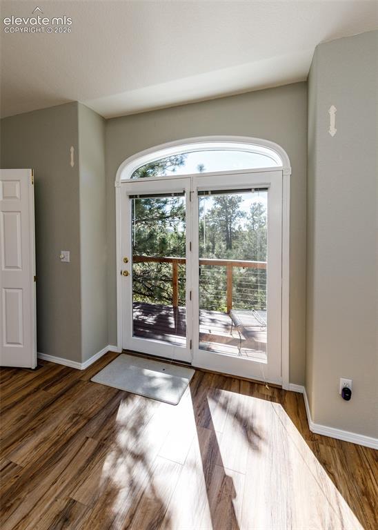 Image 14 of 48:  wooden deck with metal cable railing off Primary Bedroom