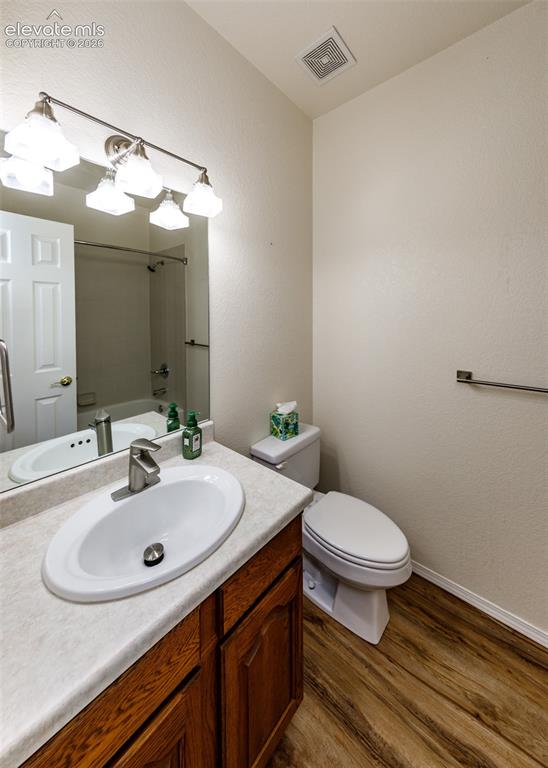 Image 22 of 48: Bedroom #2 Bathroom featuring wood-finish flooring, a vanity with a solid-s