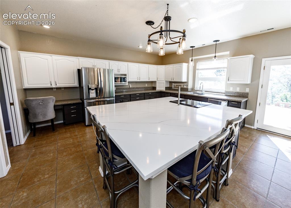 Image 28 of 48: Oversized kitchen island with quartz countertops, custom two-tone cabinetry
