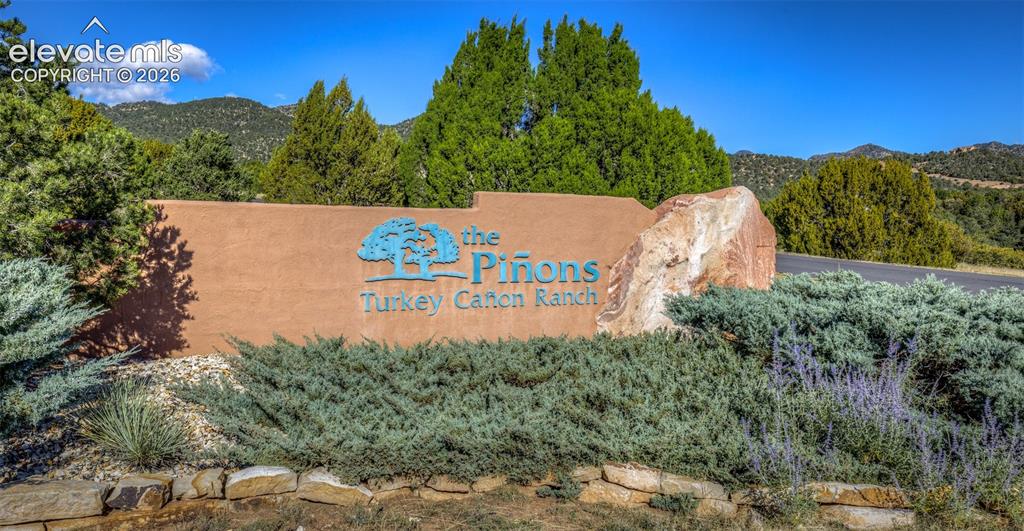 Image 48 of 48: Stucco monument signage featuring natural stone accents, complemented by ma