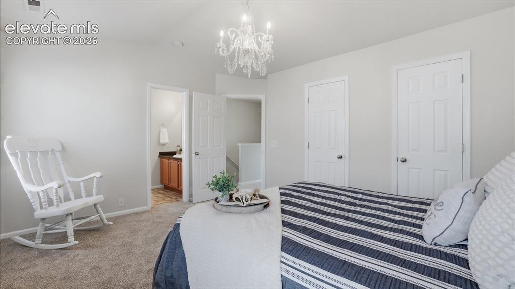 Image 19 of 29: Upper Level Primary Bedroom with neutral carpet, updated lighted, adjoining
