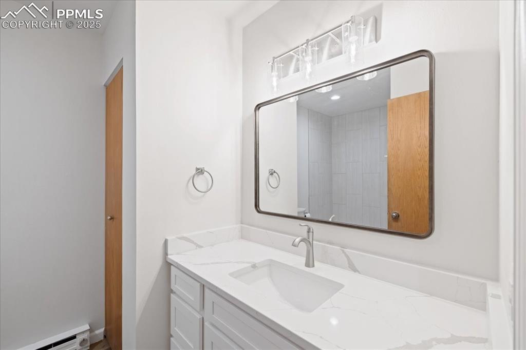 Image 10 of 17: Bathroom with vanity and a baseboard heating unit