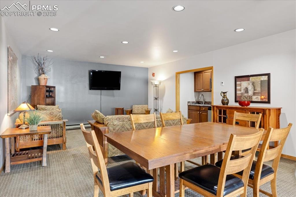 Image 15 of 17: Common area: Dining space featuring light carpet, recessed lighting, and a