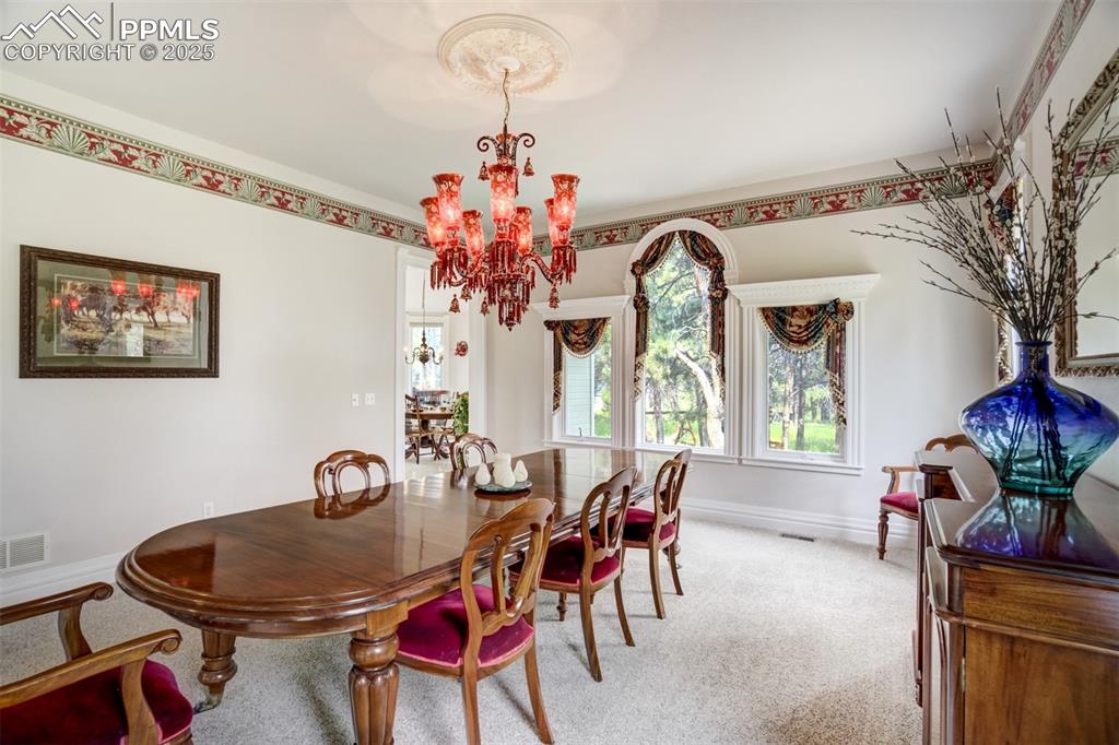 Image 11 of 50: Formal dining room with chandelier from India