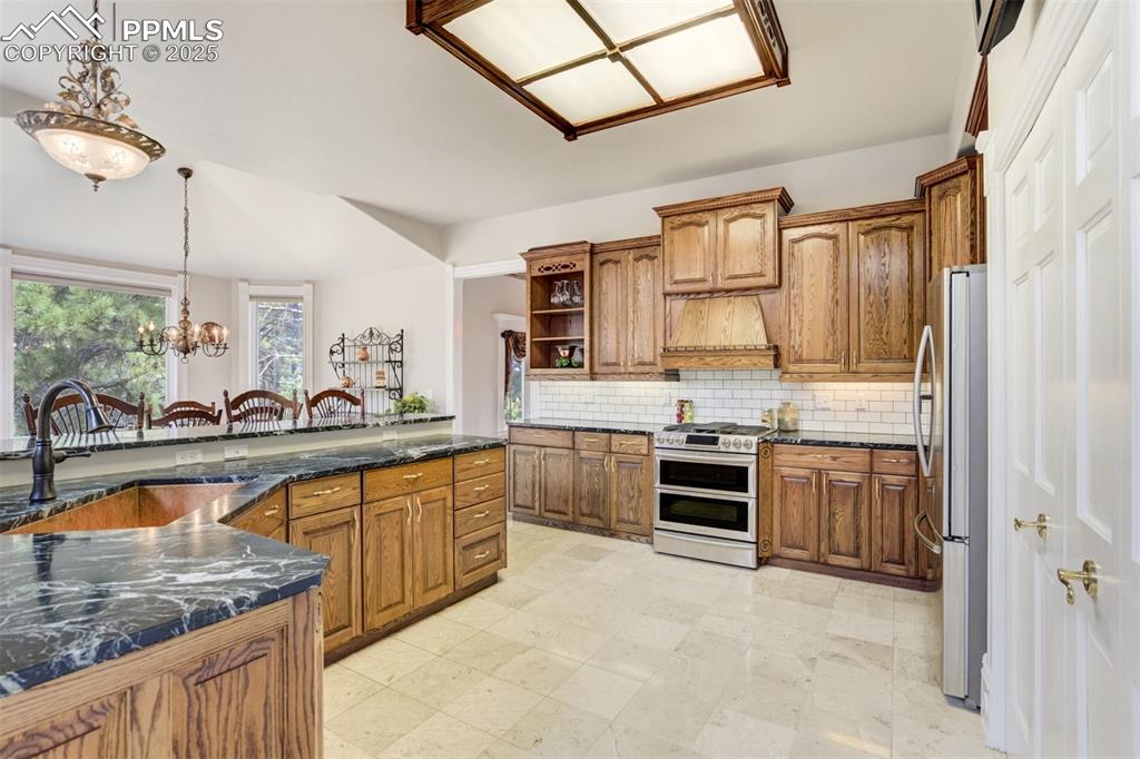 Image 16 of 50: Kitchen offers soapstone counters and a copper sink