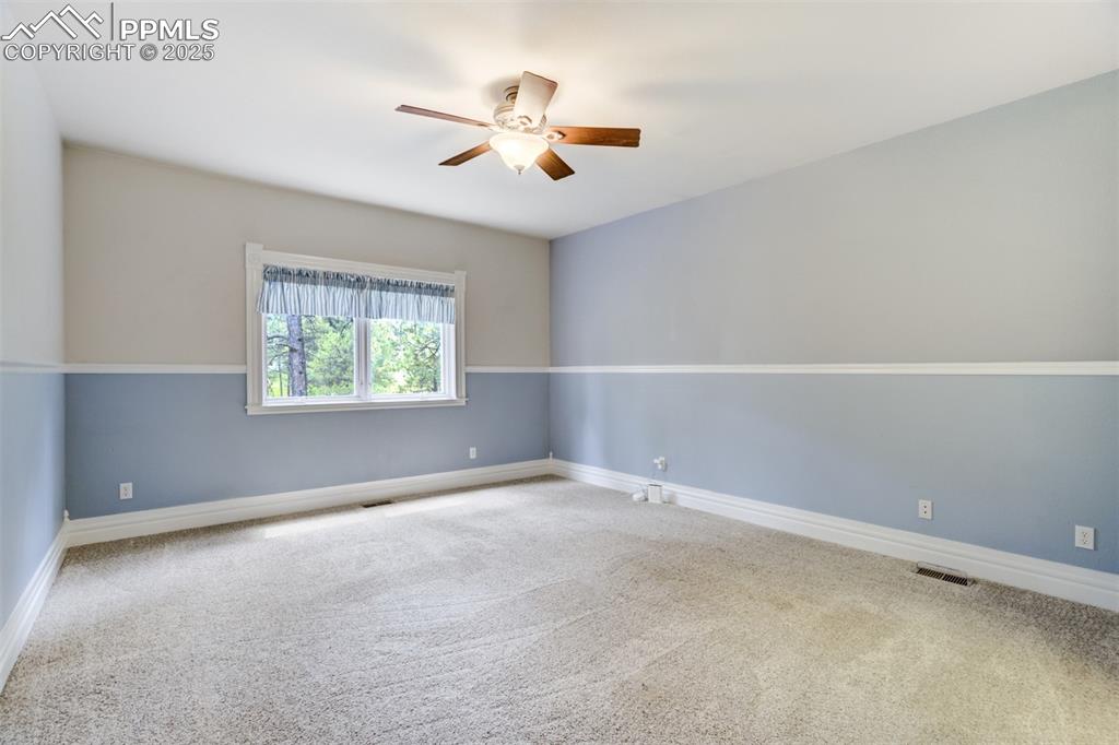 Image 30 of 50: Unfurnished room with ceiling fan and carpet floors