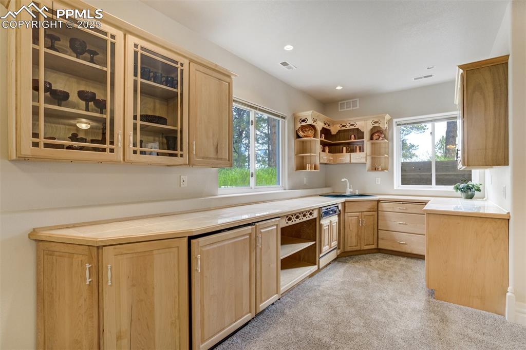 Image 32 of 50: Family room features a full kitchen for entertaining 