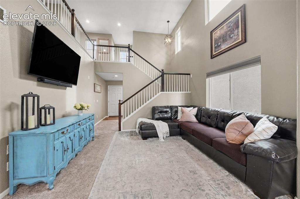 Image 6 of 34: Bright and airy living room with soaring ceilings!