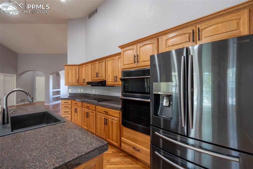 Image 10 of 49: Black Stainless Steel Appliances, Granite Tile Countertops, 14 ft high ceil