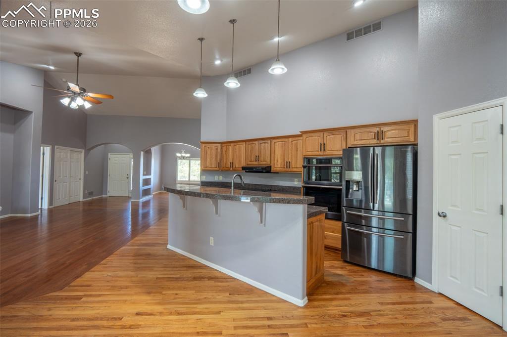 Image 12 of 49: Black Stainless Steel Appliances, Granite Tile Countertops, 14 ft high ceil