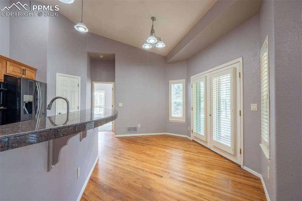 Image 13 of 49: walk out to the enclosed patio sunroom