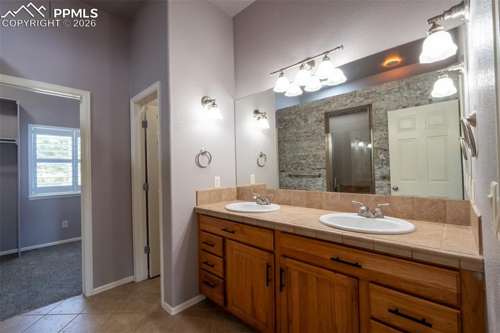 Image 16 of 49: Primary Bathroom, Walk in Closet, Dual Sinks and separate toilet room