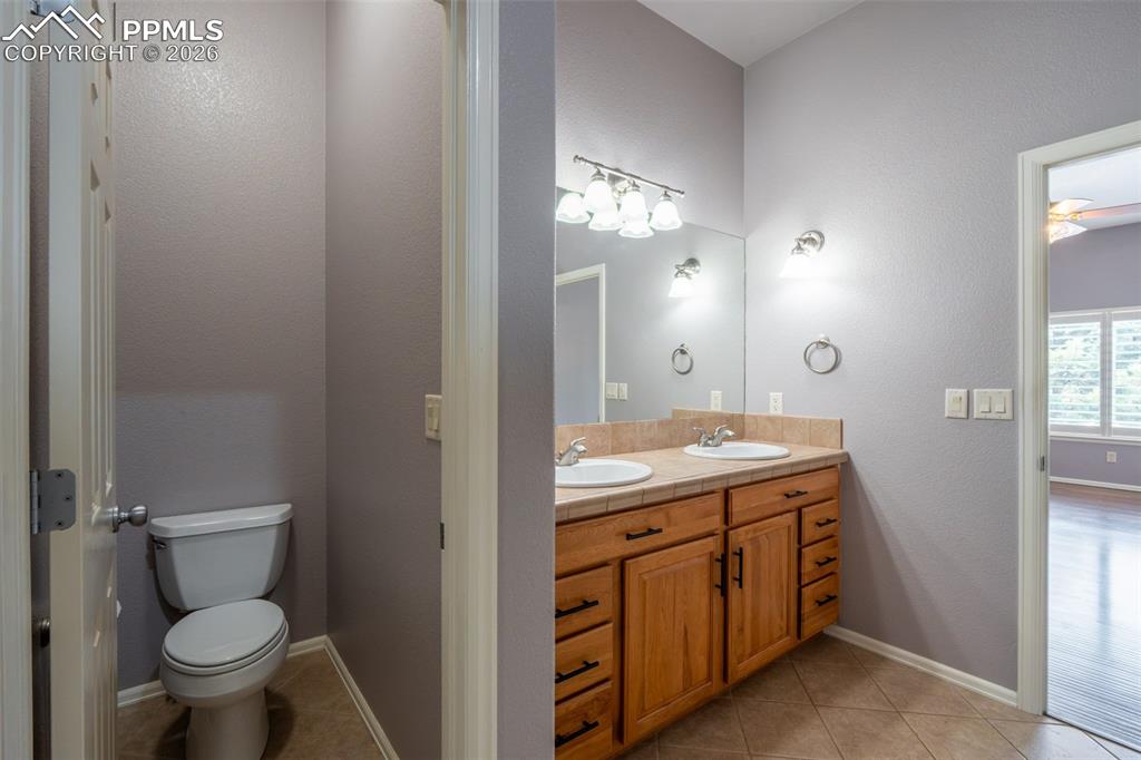 Image 17 of 49: Primary Bathroom separate toilet room and dual sinks