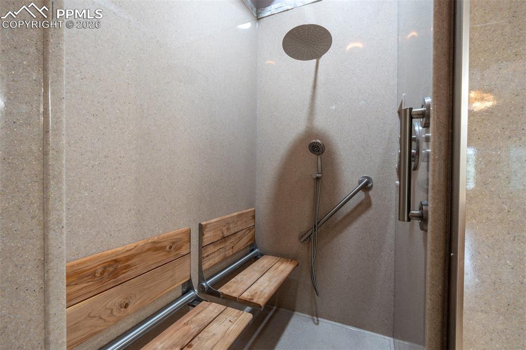 Image 19 of 49: Primary Bathroom Shower with 2 spa seat, 2 shower heads and 2 hand held spr