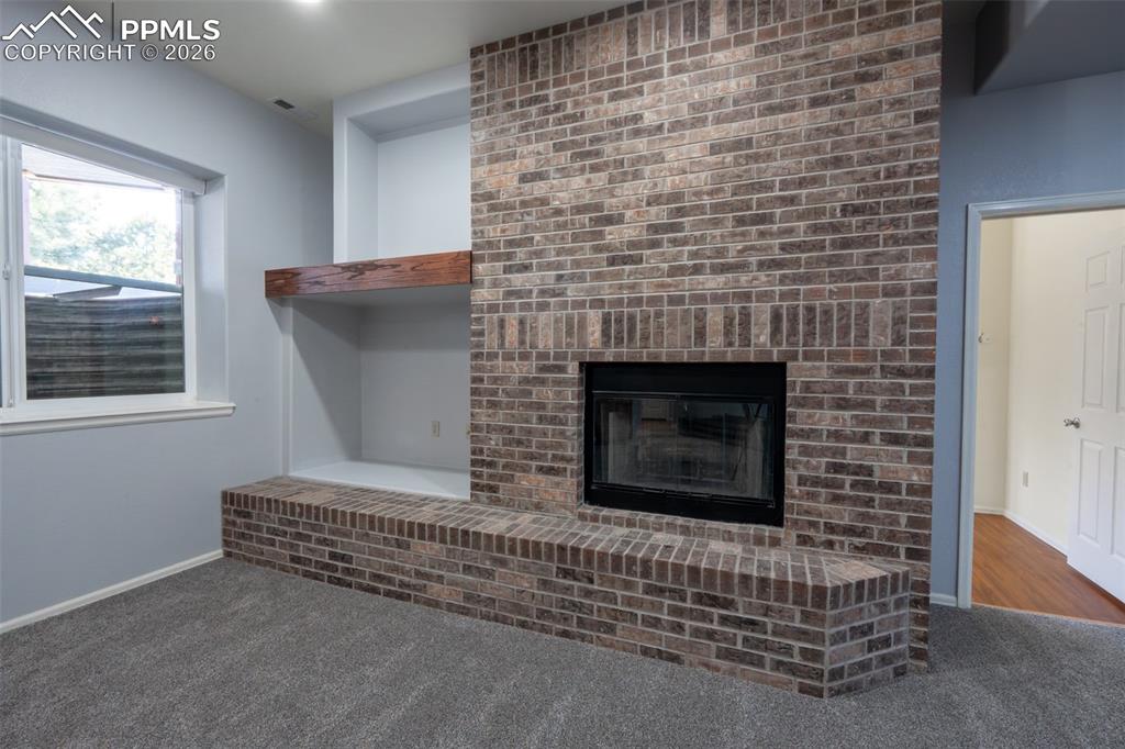 Image 33 of 49: Family Room 10 Ft ceilings, garden level, wood burning fireplace