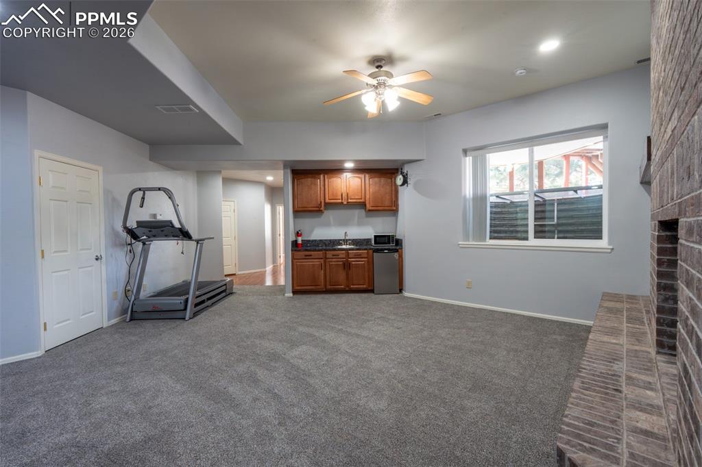Image 38 of 49: Family Room 10 Ft ceilings, wet bar, garden level, wood burning fireplace, 