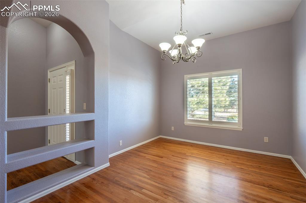 Image 5 of 49: Dining Room, wood floors, Plantation Shutters