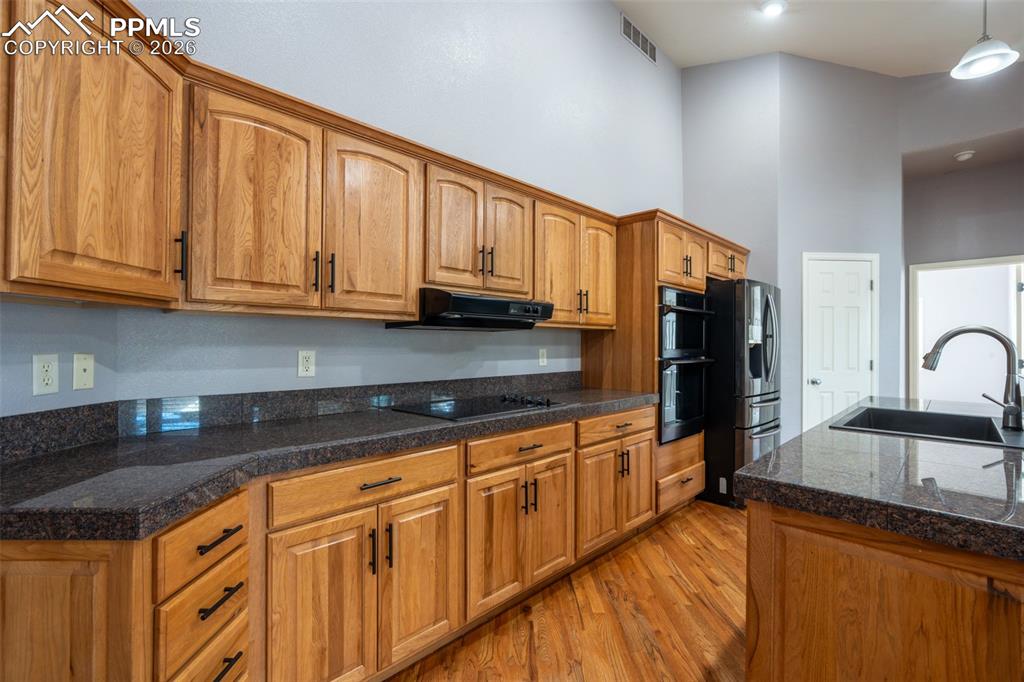 Image 9 of 49: Black Stainless Steel Appliances, Granite Tile Countertops, 14 ft high ceil