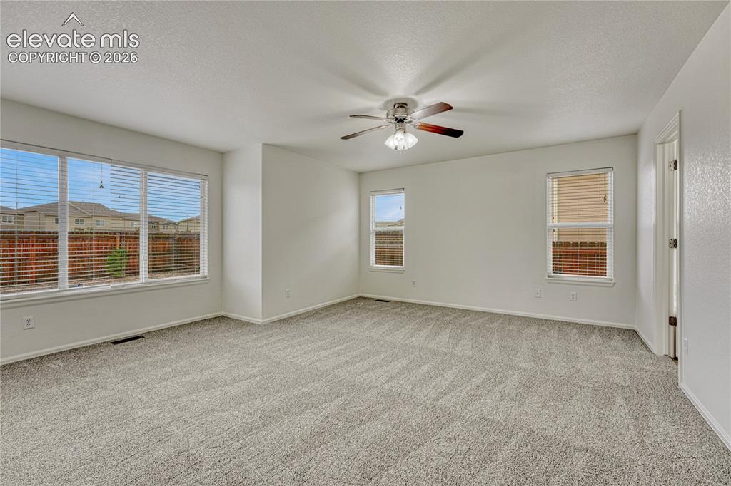 Image 13 of 36: Main level primary bedroom is light and bright. 