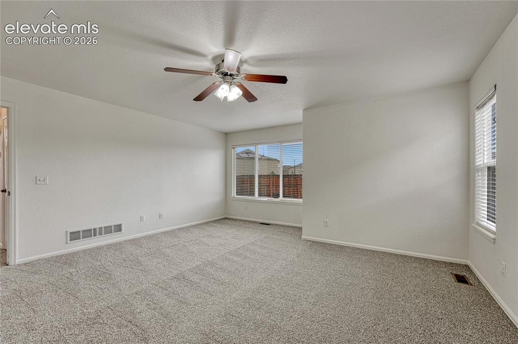 Image 14 of 36: Primary bedroom with sitting area.