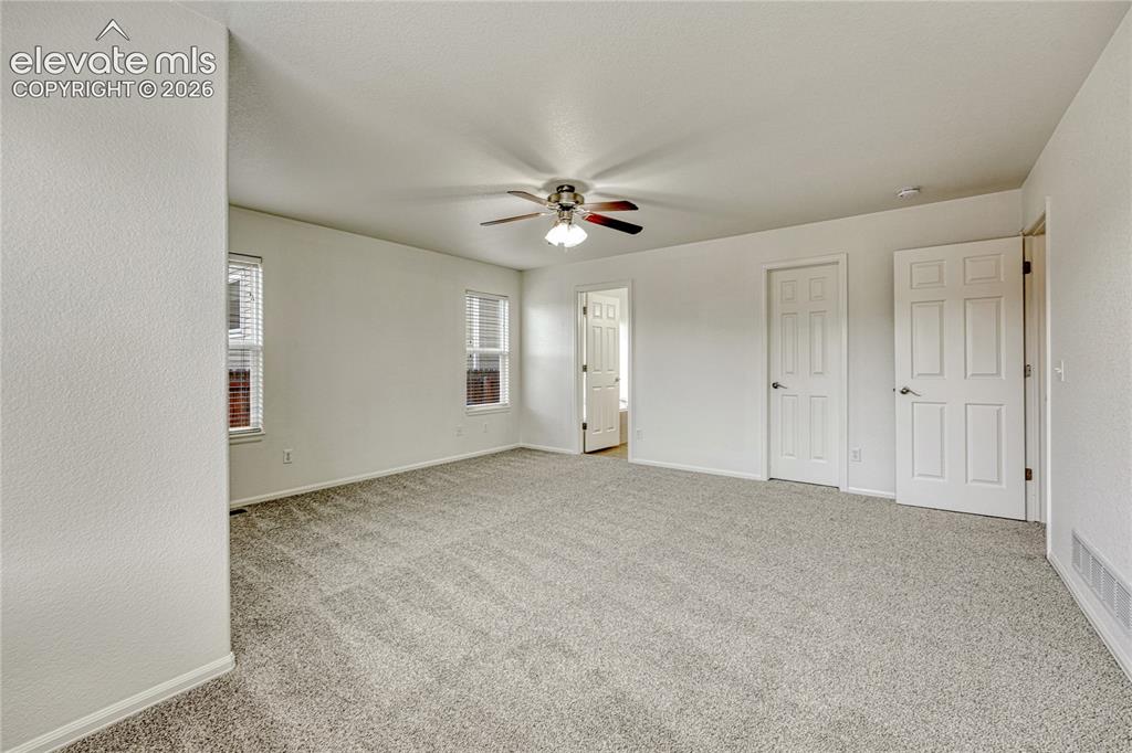 Image 15 of 36: Primary bedroom has walk-in closet and new carpet and paint.