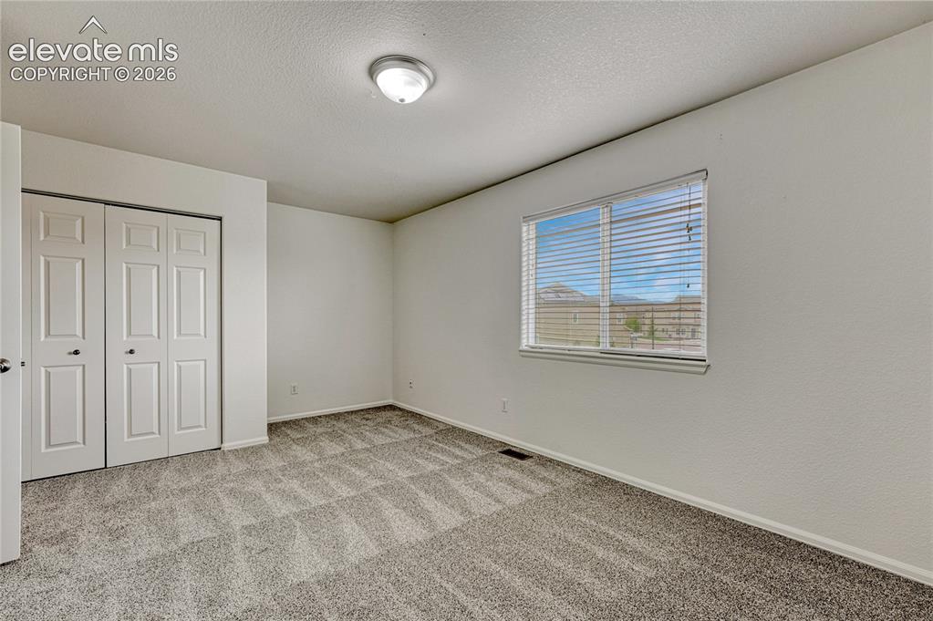 Image 23 of 36: First of two upstairs bedrooms.