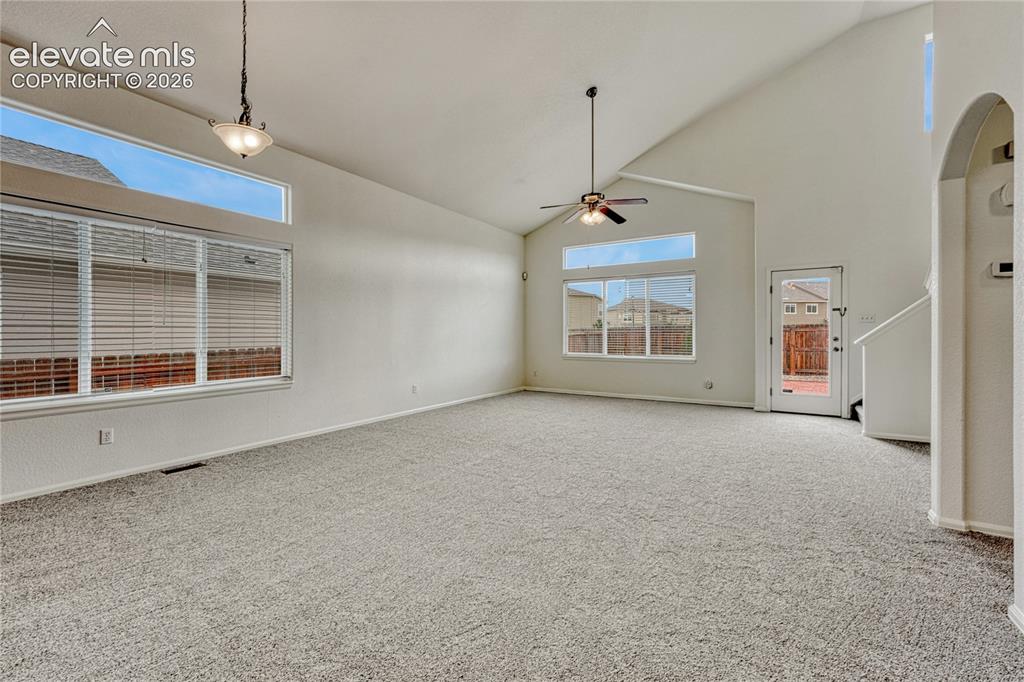 Image 4 of 36: Great room with vaulted ceiling, walk-out and lots of natural light.