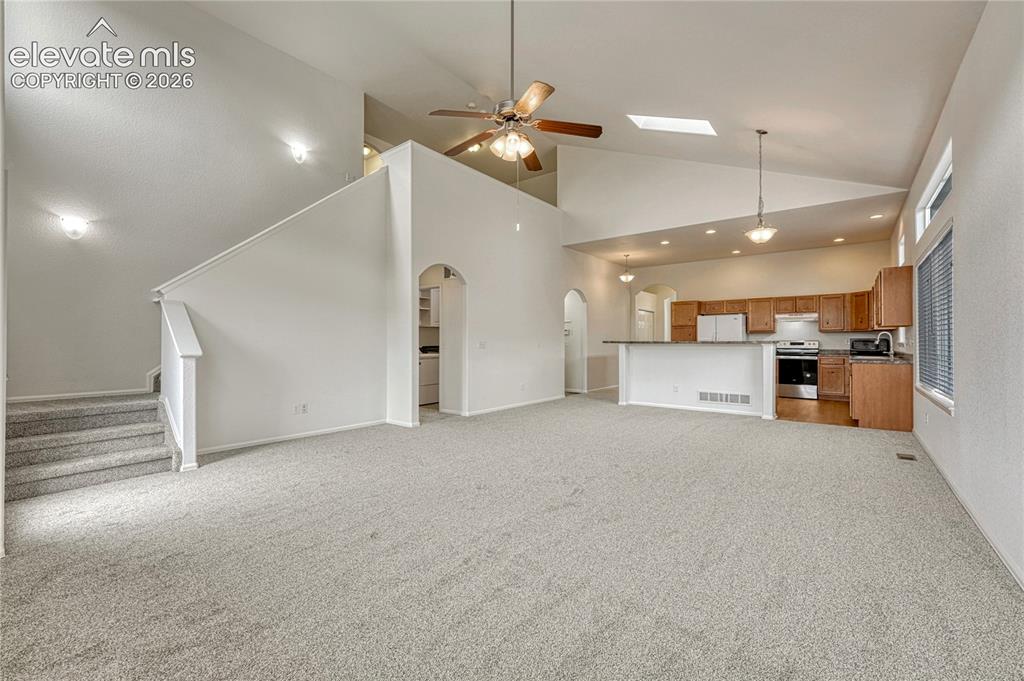 Image 6 of 36: Great room, dining space and kitchen.