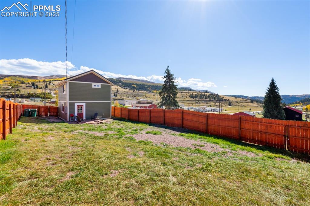 Image 17 of 19: Fenced backyard featuring a mountain view and a rural view