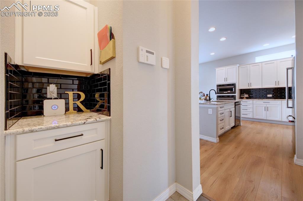 Image 29 of 42: Additional cabinets and counter, great for a coffee bar!