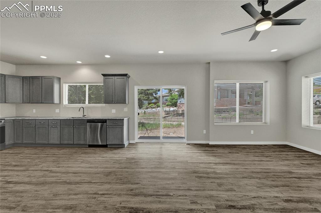 Image 10 of 38: Kitchen with dishwasher, dark wood-type flooring, plenty of natural light, 