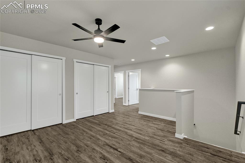 Image 19 of 38: Bedroom with multiple closets, recessed lighting, ceiling fan, and dark woo