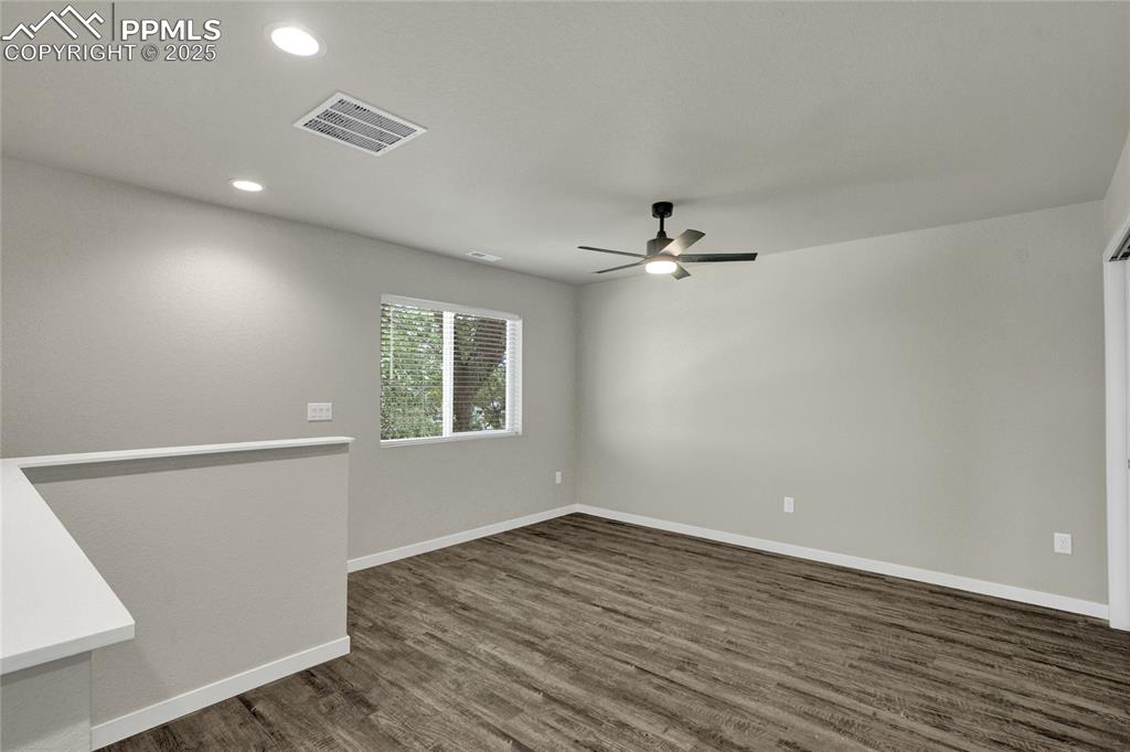 Image 21 of 38: Spare room with dark wood-style floors, recessed lighting, and a ceiling fa